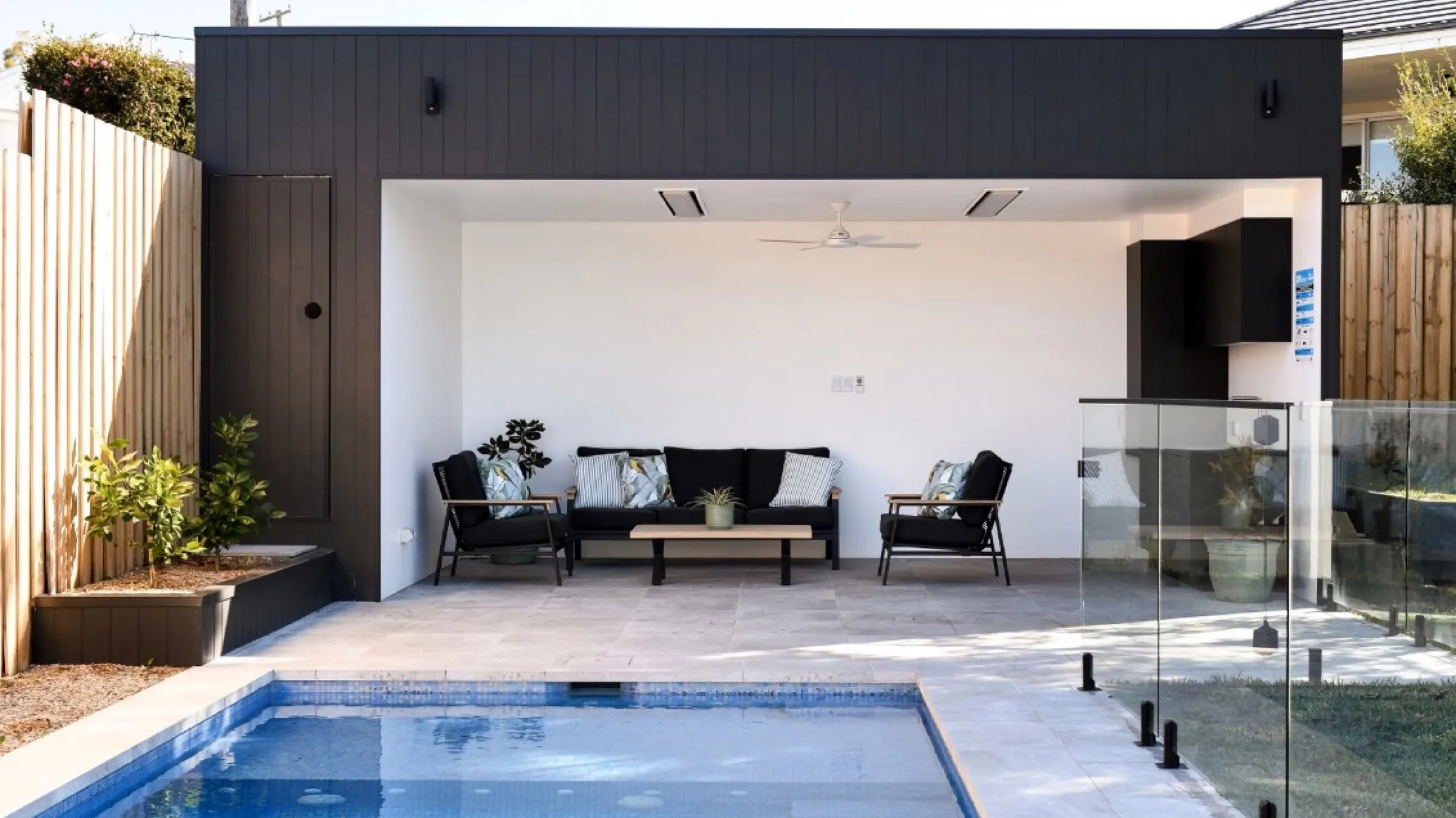 Finished pool cabana with dark cladding